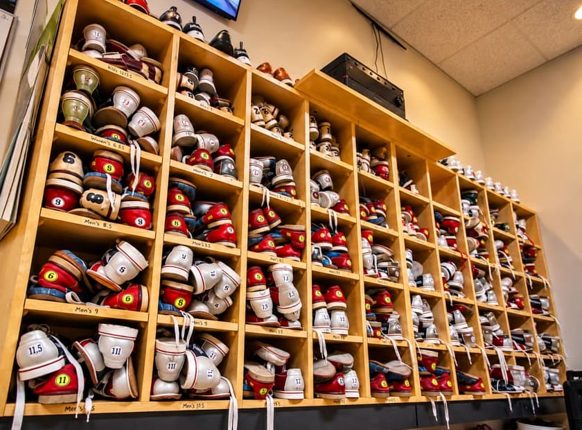 Shelves of rental bowling shoes at The Alley