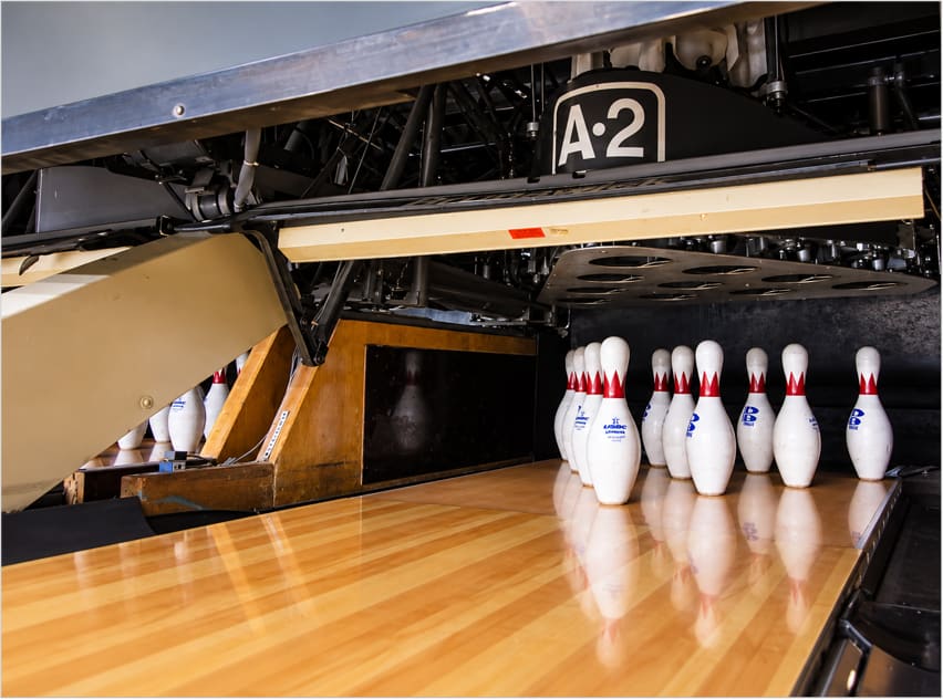 Bowling pins set at the end of a polished lane